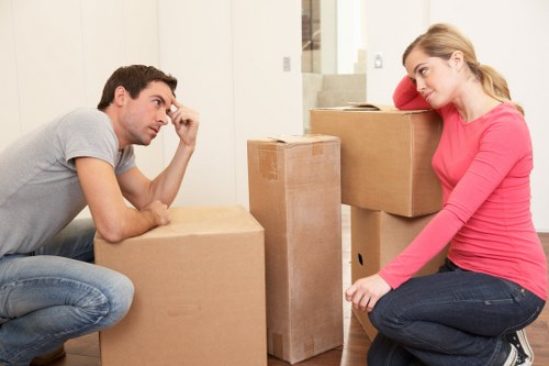 Professional movers handling desks and technology during a commercial move