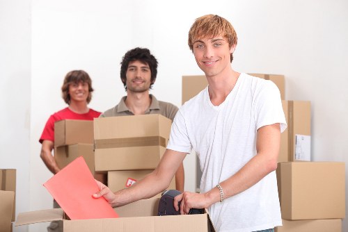 Removal crew loading household items into a van during a Waterloo move